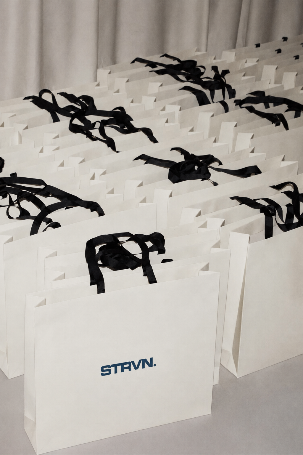Rows of STRVN branded event gift bags ready for delivery
